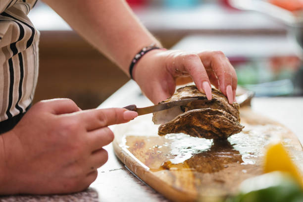istock Young Women Preparing Fresh Oysters 1135385354