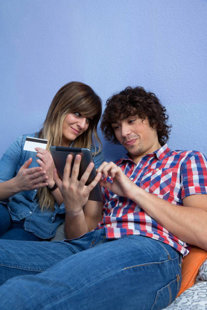 istock Woman convincing husband to make online purchase 1135388428