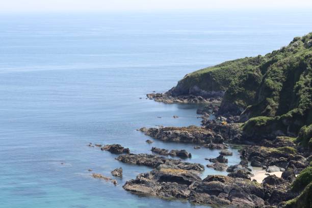 istock Cliff over the clear blue sea. 1135390322
