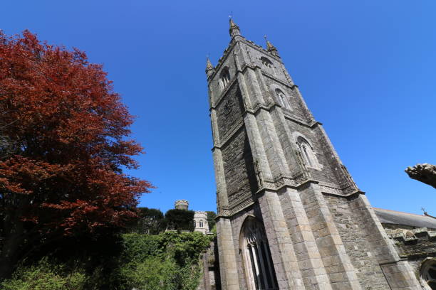 Spring in Fowey, United Kingdom. Red tree under the church tower.