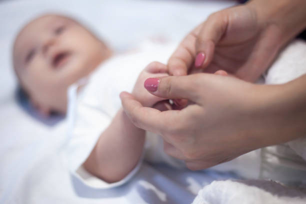 istock mother and newborn baby hands 1135391075