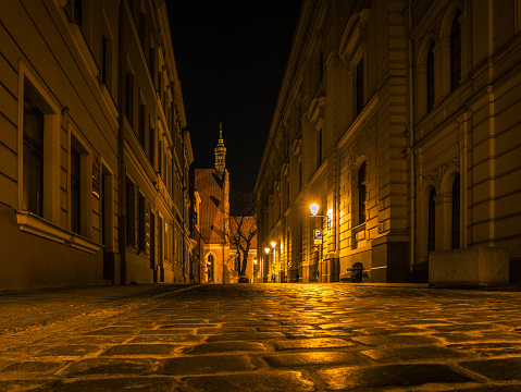 Night photography in an empty street with cobblestones
