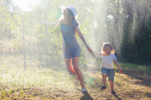 istock Mother and child having fun in the rain 1135393176