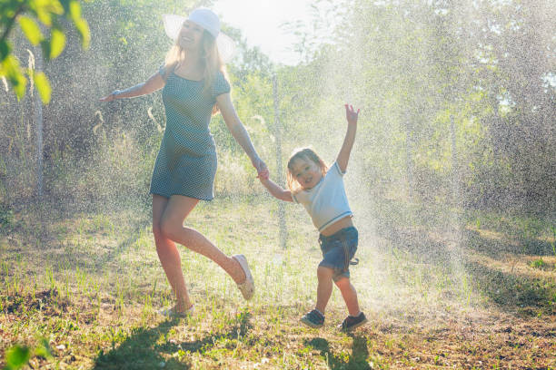 istock Mother and child having fun in the rain 1135393217