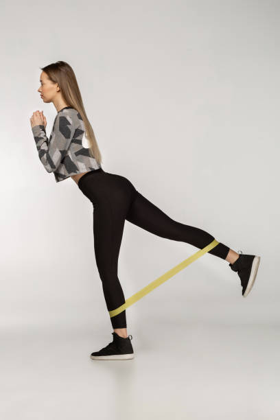 istock Attractive sportswoman performs exercises with resistance band 1135393363