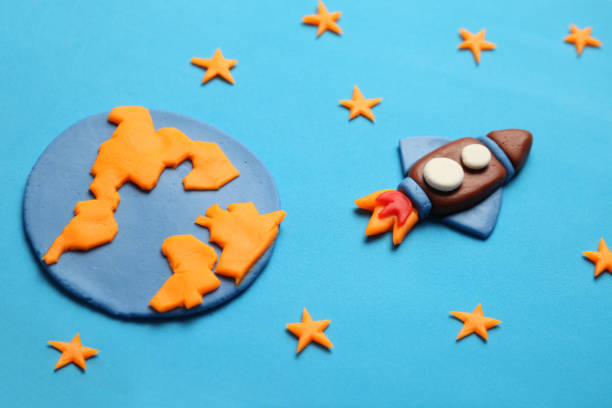 istock Rocket in space, star, planet earth. Plasticine art, cartoon 1135396046