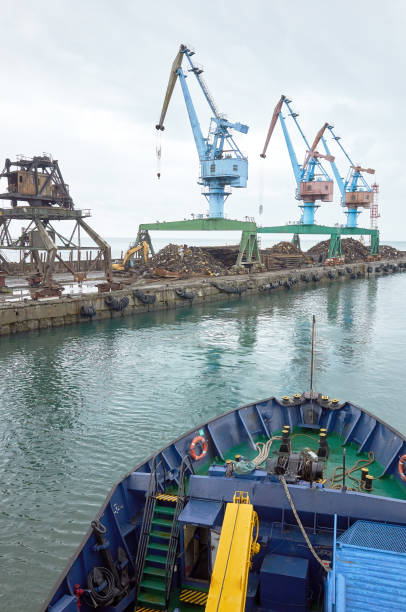 istock Port, cargo ship, sea, crane, pier, gray cloudy sky 1135397296