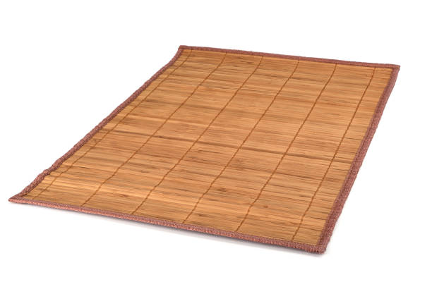 istock Bamboo sushi mat isolated on white background. Traditional Japanese or Chinese table setting. 1135398204