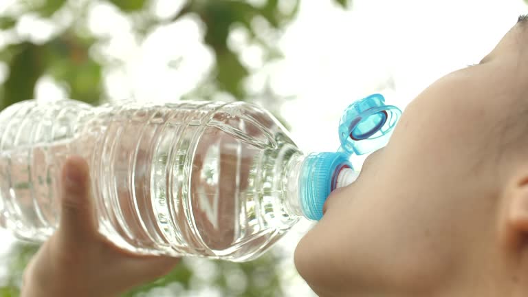 Close-up Asian Fitness Woman drinking Water after Running