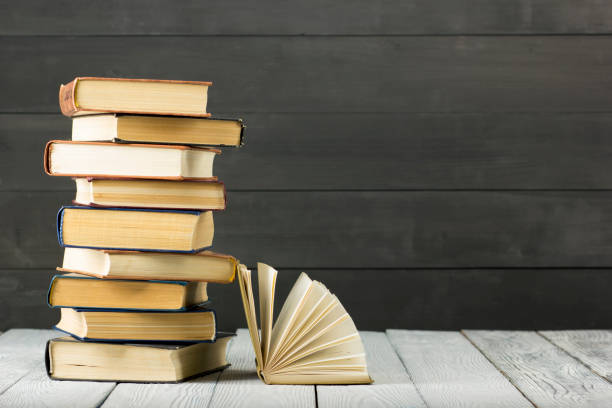 istock Open book, hardback books on wooden table. Back to school. Copy space. 1135399865