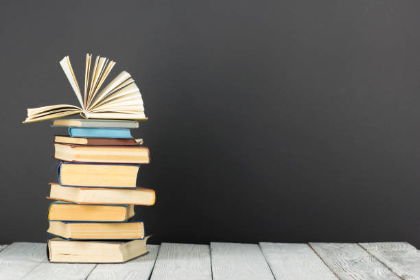 istock Open book, hardback books on wooden table. Back to school. Copy space. 1135399871