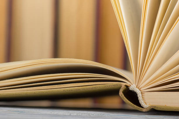 istock Open book, hardback books on wooden table. Back to school. Copy space. 1135399914