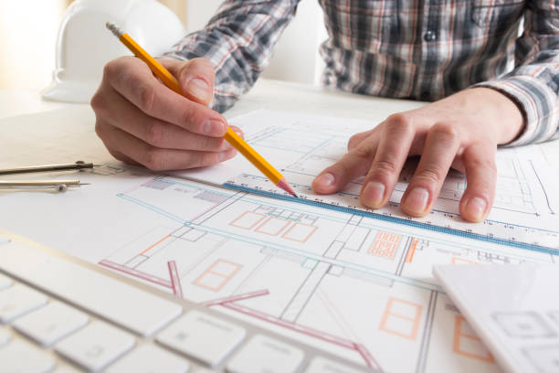 architects working on blueprint, real estate project. architect workplace - architectural project, blueprints, ruler, calculator, laptop and divider compass. construction concept. engineering tools. - housing project organization meeting real estate imagens e fotografias de stock