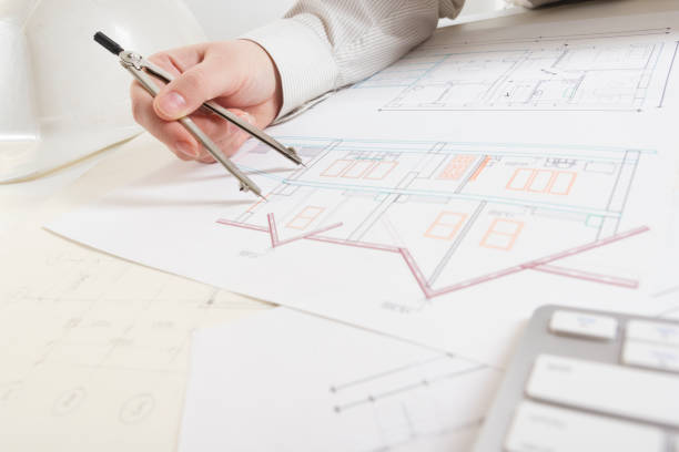 architects working on blueprint, real estate project. architect workplace - architectural project, blueprints, ruler, calculator, laptop and divider compass. construction concept. engineering tools. - housing project organization meeting real estate imagens e fotografias de stock