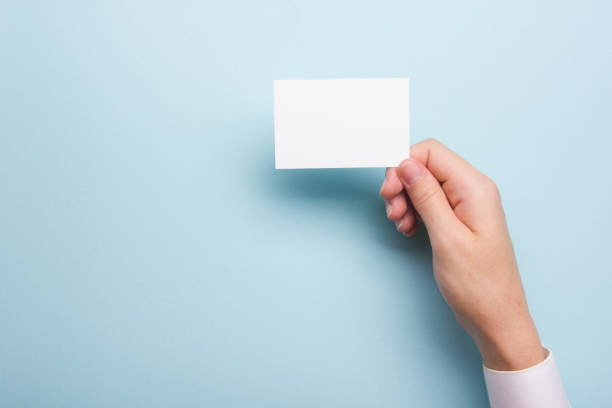 istock Hand holding white business card on white background 1135400760