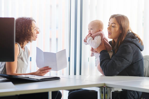 istock housing officer with young mum 1135408327