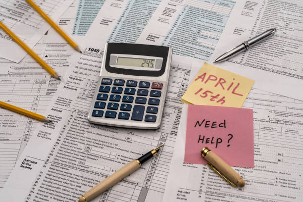 istock 1040 tax form with calculator, pen and 'need help' text 1135408409