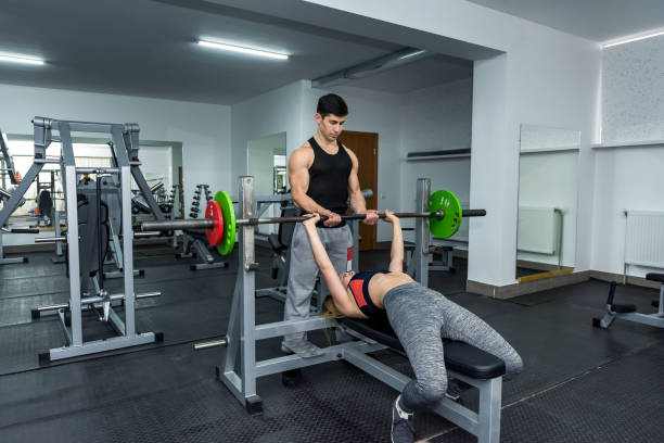 istock Coach training young and beautiful woman in gym 1135410135