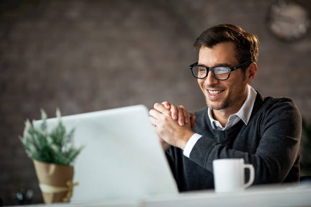 istock Happy male entrepreneur using laptop while working in the office. 1135411891