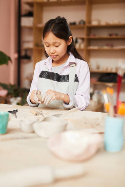 istock Asian Girl Enjoying Pottery Class 1135415941