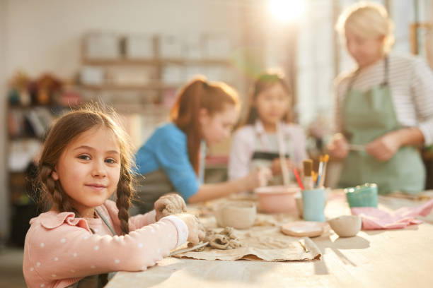istock Cute Little Girl in Pottery Class 1135415972