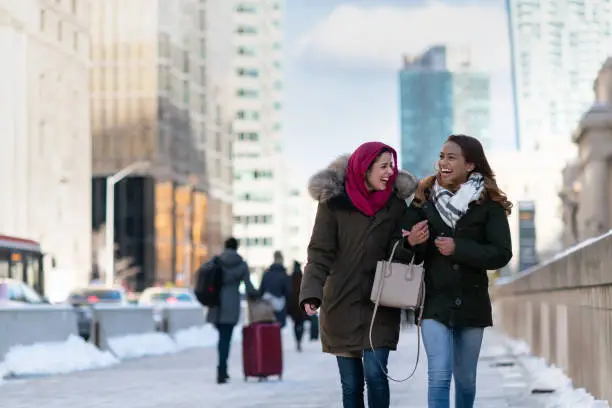 Photo of Adult female friends walking through the city