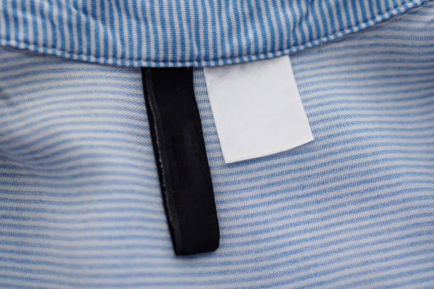 istock blank black and white clothing label on blue fabric texture background 1135419881