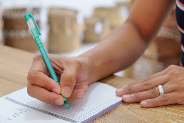 istock Mid adult women writing invoice 1135420171