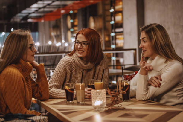 istock Mother and daughters having coffee at the cafe 1135420206