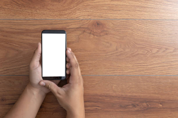 istock Man hand holding the black smartphone screen mockup 1135421074