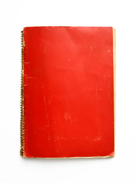 istock Isolated shot of old red spiral notebook on white background 1135421913