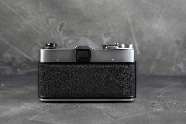 istock The old 35 mm SLR camera on grey cement background. 1135422194