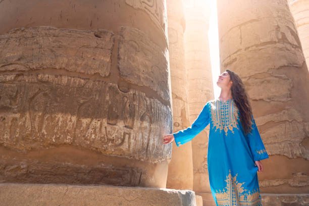Exploring The Ancient Treasures Beautiful caucasian woman enjoying a tour at the Great Temple of Amun in Karnak, Egypt. temple of luxor hypostyle hall stock pictures, royalty-free photos & images
