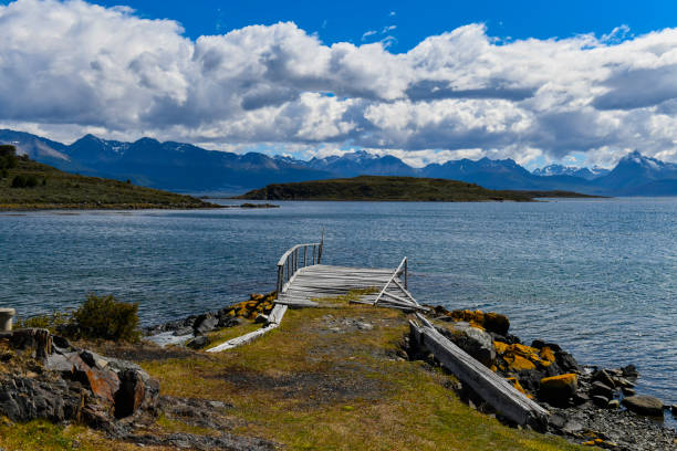 The Beagle Channel and coastline with a wooden pier located in the western of the Navarino Island in Puerto Navarino, Chile
