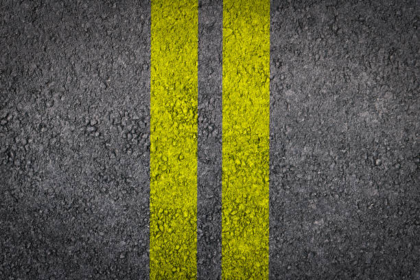 istock Double Yellow Line On New Asphalt Road texture background 1135425676