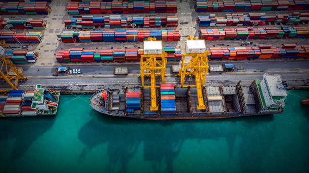 istock Logistics and transportation of Container Cargo ship and Cargo plane with working crane bridge in shipyard, logistic import export and transport industry background 1135428101