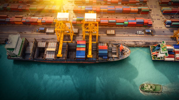istock Logistics and transportation of Container Cargo ship and Cargo plane with working crane bridge in shipyard, logistic import export and transport industry background 1135428130
