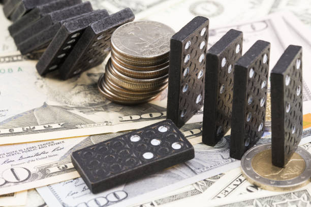 istock US dollar currency instability concept with stacked coins an dominos 1135429267