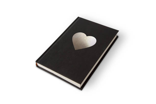 istock Black book with silver cross on white background with outline paths for easy editing. 1135429821