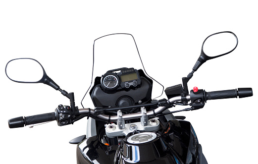 Close up of motorbike handlebars, dashboard and mirrors isolated on white background, full frame horizontal composition with copy space and clipping path insluded