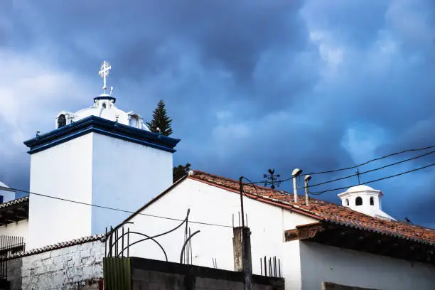 Modern white churchtowers on dramatic blue cloudscape in Antigua, Guatemala