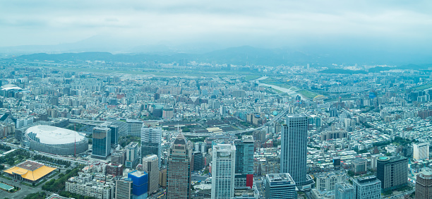 Aerial panorama over Taipei, capital City of Taiwan, on a blue sky and cloudy day