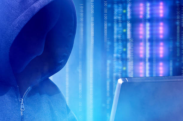istock Close up view of hacker in black hoodie holding laptop with binary code on virtual screen 1135436667