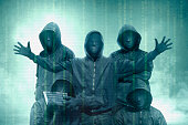 Hacker groups in black hoodie standing with binary code on virtual screen