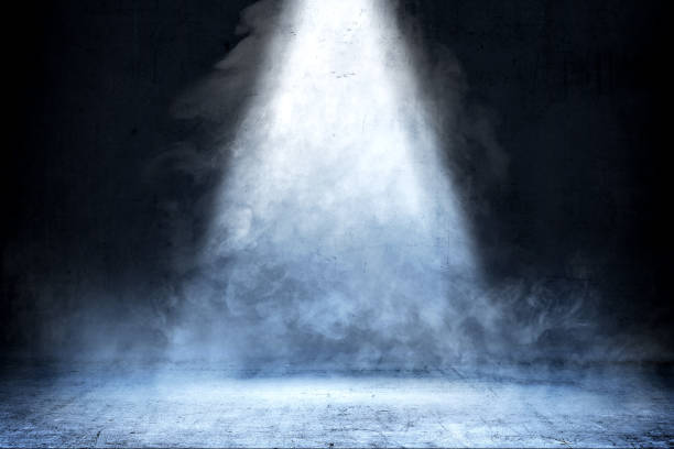 Room with concrete floor and smoke with light from the top