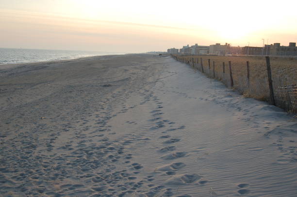 Footsteps on rockaway beach in winter