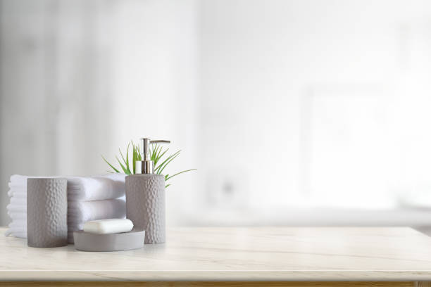 istock Towels and ceramics shampoo or soap on top marble table with copy space on blurred bathroom background. 1135441518