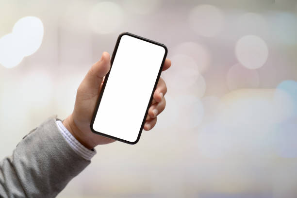 istock Man hands holding blank screen smartphone with blurred background.  Blank screen mobile phone for graphic display montage.