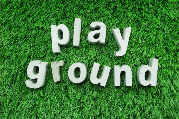 istock playground word alphabet letter top view on green grass 1135441588
