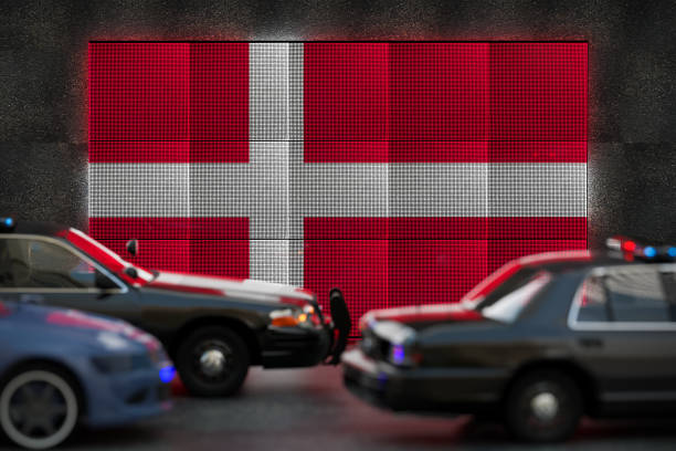 Bright digital display Denmark flag in city as cars drive past